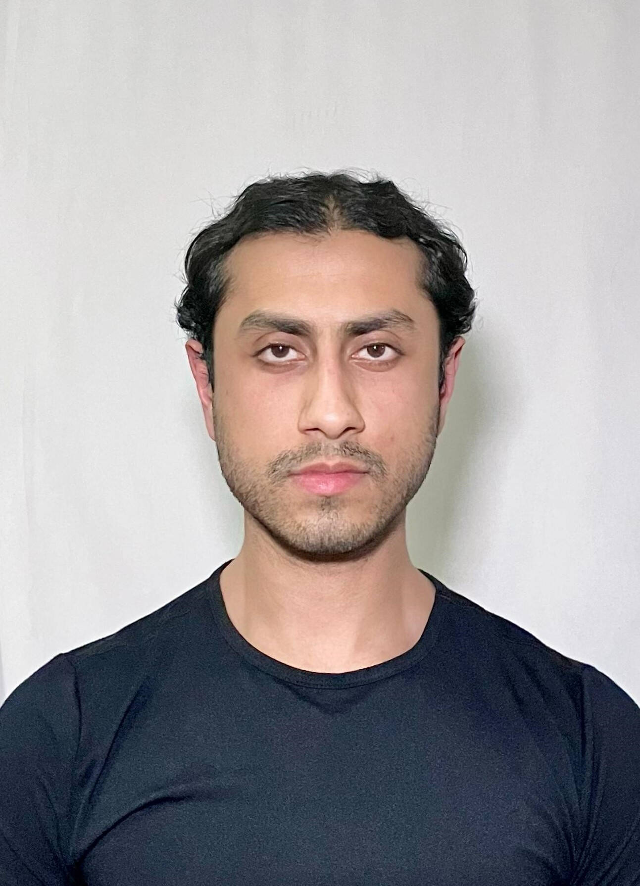 Image of Talha Khan in a black shirt on a white background.